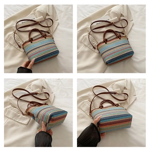 Detail view of colorful striped straw bag featuring leather handles and adjustable strap