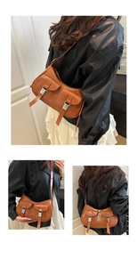 Close-up of brown faux leather shoulder bag featuring dual front pockets and silver buckles