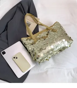 Detailed size comparison of a gold sequin tote bag showing large capacity with an iPad