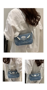 Detail of denim shoulder bag with pearl chain, metal floral strap and fashion leather patch