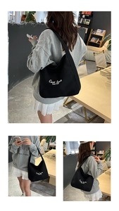 Detail view of a black canvas tote bag with white lettering for daily commute