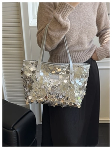 Silver sequin tote bag with Creative Cat label shown in a stylish indoor lifestyle setting