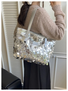 Silver sequin tote bag with Creative Cat label shown on a model for size perspective
