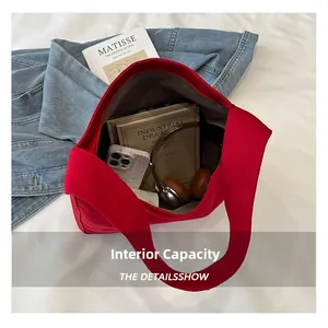 Top view of red canvas tote bag interior showing large capacity for books and phones