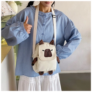 Cute capybara canvas crossbody bag with adjustable strap worn by model in casual setting