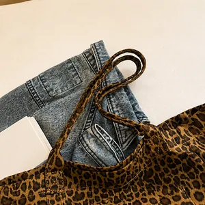 Close-up of leopard print canvas bag showing reinforced stitching and durable handle