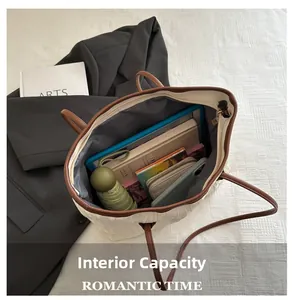 Spacious interior of a quilted tote bag showing compartments for laptop and essentials