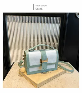 Detail of green and white square bag with triangle pattern on art books