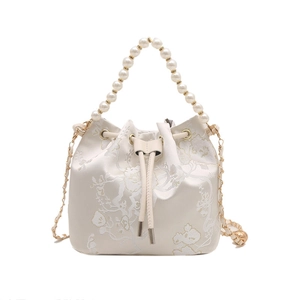 Elegant off-white embroidered bucket bag with pearl handle and floral bird patterns