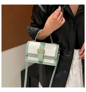 Detail of sage green and white small square bag with geometric embossed texture