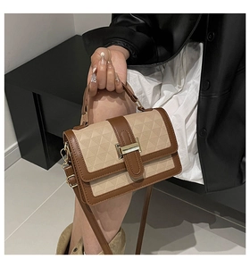 Detail showing the geometric embossed pattern and golden buckle on this faux leather bag