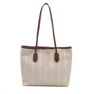 Chic cream tote bag with wavy texture and brown leather handles for women's summer fashion