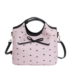 Sac seau rose avec motifs nœuds noirs, poignée en cuir et bandoulière réglable
