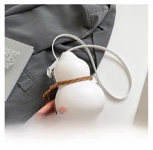 Macro view of white gourd-shaped crossbody bag featuring braided rope and PU leather details