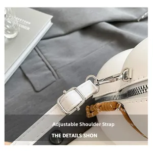 Close-up of adjustable white leather strap with silver metal buckles and woven detail