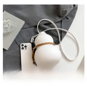 Detail view of the unique gourd-shaped white crossbody bag with woven rope accent