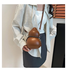 Macro view of warm brown gourd-shaped crossbody bag with decorative braided rope detail