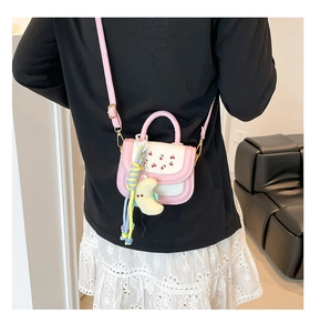 Mini pink and white crossbody bag with cherry pattern and yellow plush charm detail