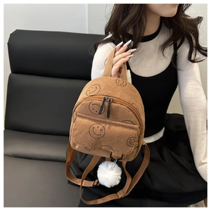 Brown corduroy mini backpack with smiley print and soft white fur ball keychain accessory