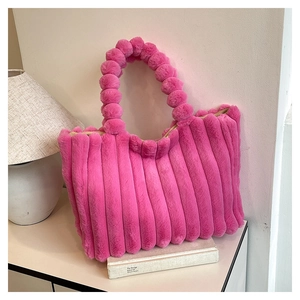 Detailed macro view of vibrant pink faux fur tote bag with plush vertical stripes