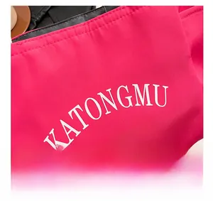Detail of rose red nylon fabric showing artistic KATONGMU white printed lettering