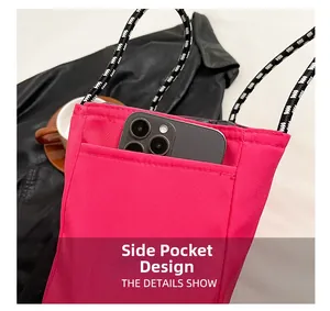Detail show of rose pink nylon bag featuring a practical side pocket for smartphone