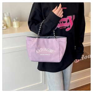 Detail of lavender nylon tote bag with rope handles and printed white lettering