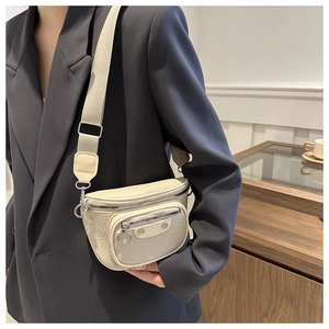 Detail of off-white textured crossbody waist bag with silver zipper and wide nylon strap