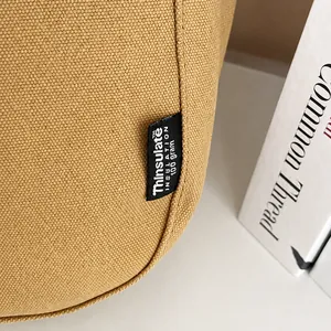Detail van het Thinsulate 100g label op een minimalistische canvas shopper tas