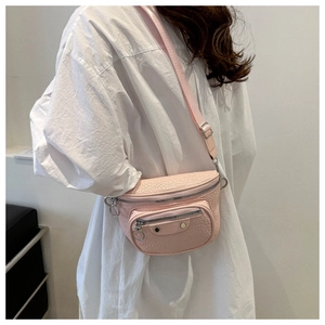 Pink faux crocodile leather waist bag with silver hardware and ring zippers shown on model