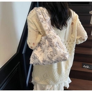 Detailed back view of a white lace tote bag with realistic black butterfly embroidery