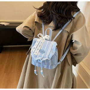 Detailed back view of a mini blue plaid backpack with lace bow and drawstring flap closure