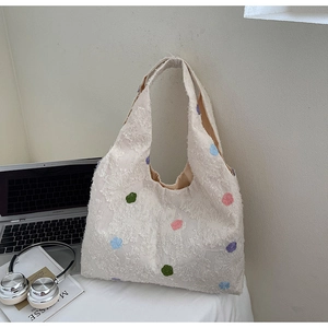 White textured canvas hobo bag with multi-color plush dots and fringe details for daily use