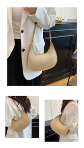 Detail view of champagne gold half-moon bag with lychee grain texture and metal zipper