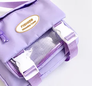 Close-up of light purple nylon crossbody bag with PVC window and white buckle detail