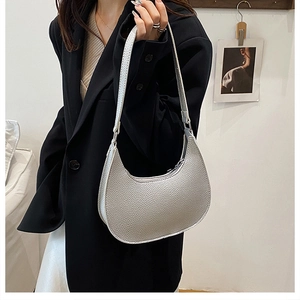 Silver hobo bag with pebbled leather texture and crescent shape detail