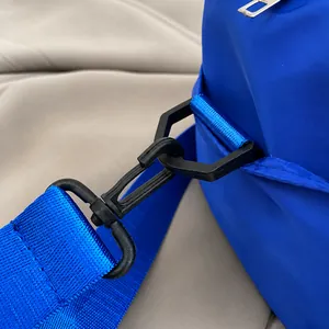 Macro detail of royal blue nylon bag showing durable matte black hook and strap