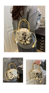 Detail of sequin bucket bag with drawstring closure and golden chain shoulder strap
