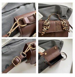 Detail view of brown patchwork bag with gold hardware and leopard print scarf handle
