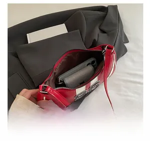 Internal view of hobo bag showing capacity for phone, wallet and lipstick