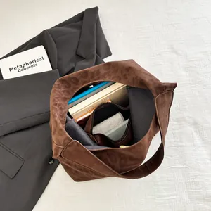 Detail view of spacious brown tote interior holding books and a tablet for daily commute