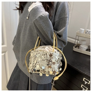 Detail of silver paillette bucket bag with drawstring liner and chain strap