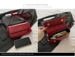 Detail of red patent leather crossbody bag showing dual magnetic closure and internal capacity