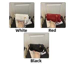 Detailed close-up of glossy patent leather crossbody bags in white, red and black finishes