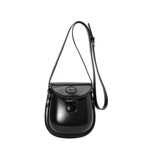 Retro black mini saddle bag with glossy finish and adjustable shoulder strap for women