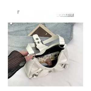 Top view of white pleated underarm bag showing spacious interior with daily essentials