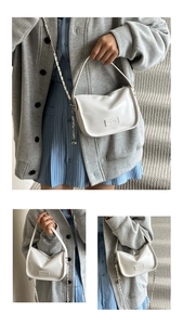 Detailed view of white PU leather shoulder bag with silver chain and embossed logo accent