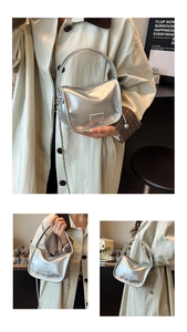 Detail of silver metallic handbag featuring Fashion logo and delicate chain strap