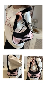 Detailed views of pink jacquard tote with black bows and heart-shaped silver pendant