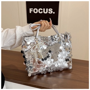 Close-up of a silver sequin shoulder bag featuring an elegant pearl tassel accessory